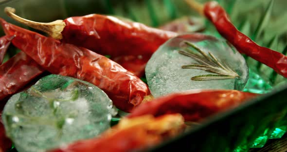 Flavored ice cubes with herb and dried red chili pepper 4k alt