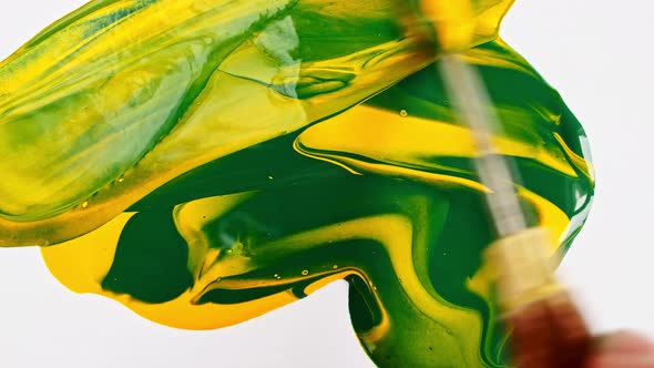 Artist Mixing Ingredients Green and Yellow Watercolor Using Palette Knife and Pigments on White alt