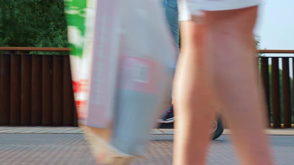 Girl in Jeans Rides Electric Kick Scooter in Park