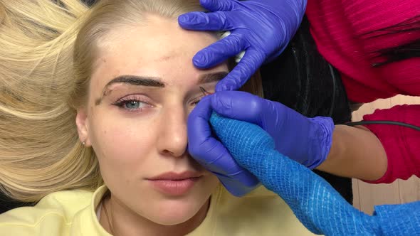 Close Up of Cosmetologist Making Permanent Makeup