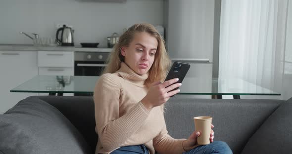 Young Blonde Woman at Home Smiling Girl Using App and Browsing on the Internet Typing Message on alt