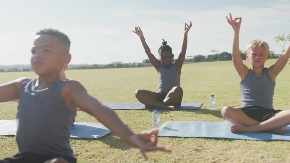 Video of diverse boys practicing yoga on mats on sunny day alt