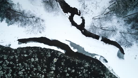 Icy River And Frozen Ground Surface Covered With Snow