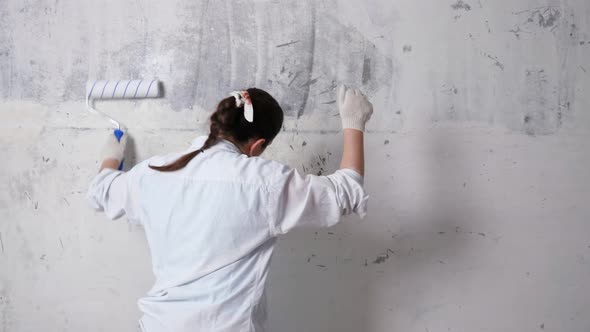 Inspired Designer Dances Painting Wall with Roller alt
