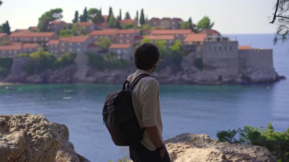 A Man Traveler Visits the Sveti Stefan Island alt