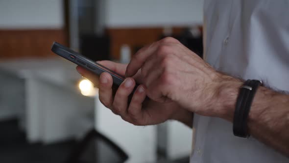 Man Using His Phone in a Company Room alt