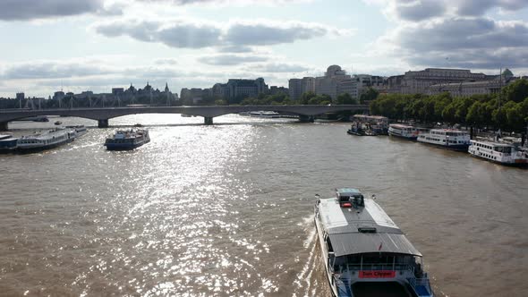 Forwards Tracking of Passenger Ship Floating on Shinny Surface of River Thames alt