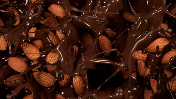 Super Slow Motion Shot of Almonds Falling Into Melted Chocolate at 1000 Fps alt