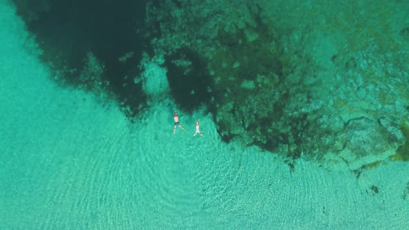 Transparent sea water near stony remote coast alt