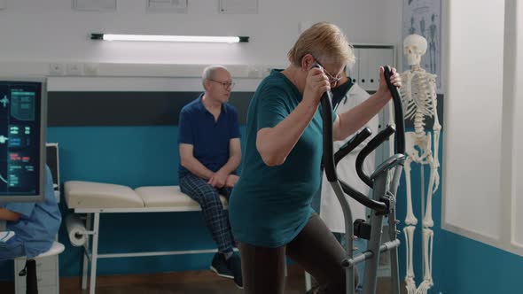 Portrait of Senior Woman Doing Physical Therapy on Stationary Bicycle alt