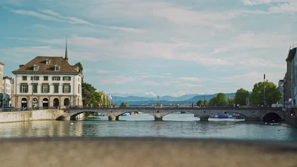 Gimbal Shot of Zurich Munsterbrucke on Background of Alps