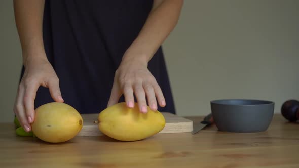 Slowmotion Shot of a Young Woman Lays Out Tropical Fruits on the Table alt