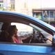 Happy Woman in a Car Looking Out of the Window - VideoHive Item for Sale