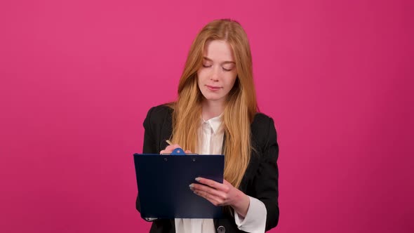 Close Up of a Businesswoman Write on a Paper Isolated on Pink Background alt