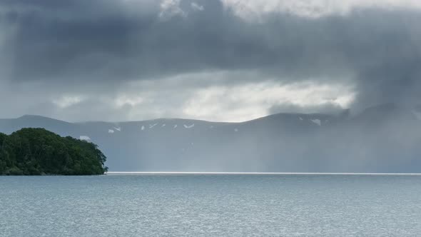 Lake and Gray Rain Clouds on Kamchatka alt