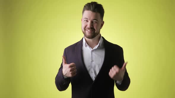 Excited Bearded Young Man in Office Suit Showing Thumbs Up Like Gesture