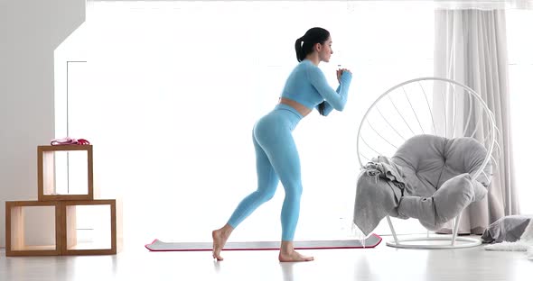 Fitness athlete performs exercises on the buttocks at home.