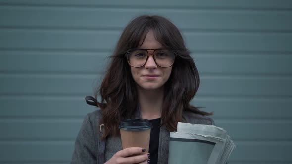 Slow Motion Portrait of Business Woman in Eyeglasses with a Cup of Coffee