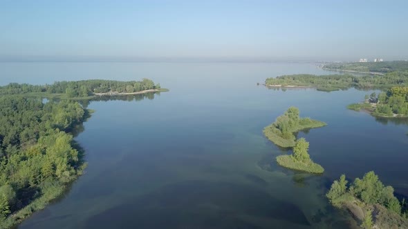 Picturesque Landscape with River, Small Islands Covered Trees in Sunny Morning, Calm Aerial