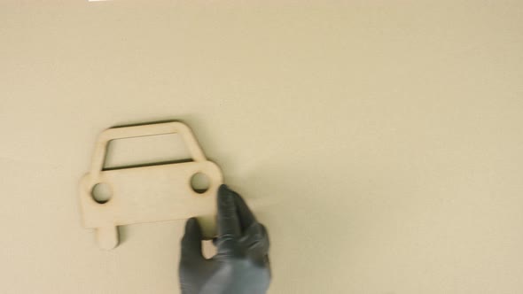 Placing Car Icon Made of Recycled Cardboard on the Table alt