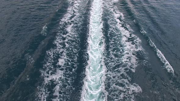 Motor Boat Sails Along the Bay of Kotor Leaving a Foamy Trail alt