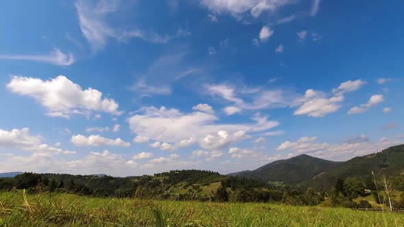 Time Lapse Beautiful Clouds Floating By the Sky Above Mountains in Sunny Day alt