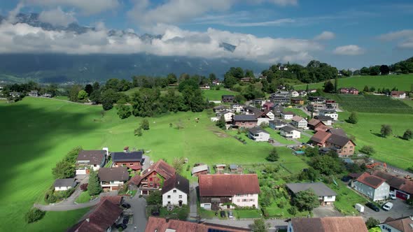 Aerial View of Liechtenstein with Houses on Green Fields in Alps Mountain Valley alt