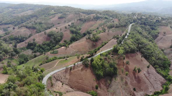 Aerial top view of sky road over top of mountain green jungle, Transportation road across mountain alt