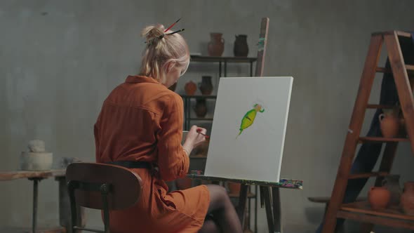 Woman Painter Creating Colorful Painting in Workshop alt