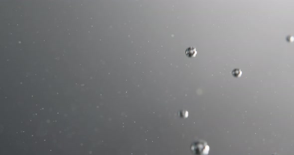 Silver Bubbles Forming And Rising Through Water alt