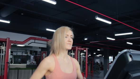 Young woman training on treadmill