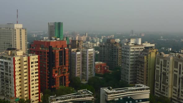 Forward Aerial Pan of Tall Buildings in New Delhi on a Foggy Day alt