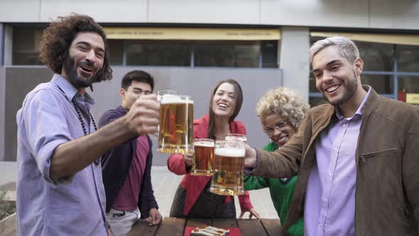 Happy Multiracial Friends Toasting Beer in a Celebration Looking to Camera alt