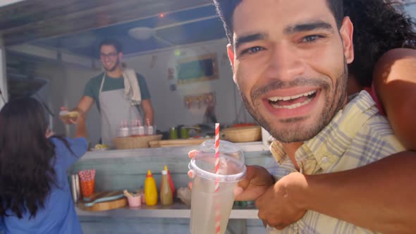 Man giving piggy back to woman alt