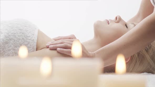 Young, healthy and beautiful woman gets massage therapy in the spa salon. alt