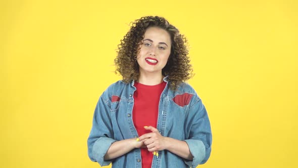 Beautiful Girl Is Reporting and Tells a Lot of Interesting Informations on Yellow Background, Slow alt