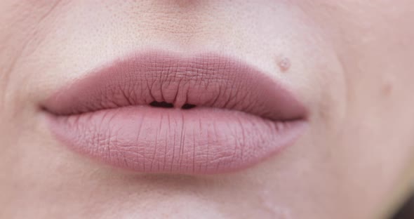 Extreme Close-up Female Mouth with Pink Lipstick Smiling Showing White Healthy Beautiful Teeth