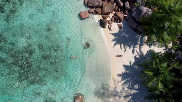 Praslin Seychelles Tropical Island with Withe Beaches and Palm Trees Couple Men and Women Mid Age on alt