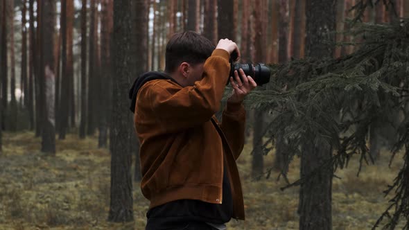 A Photographer Takes Pictures in the Woods a Young Man Takes Pictures in the Woods with His Camera alt