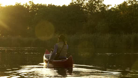 Cowboy in a Canoe Floats on the River alt