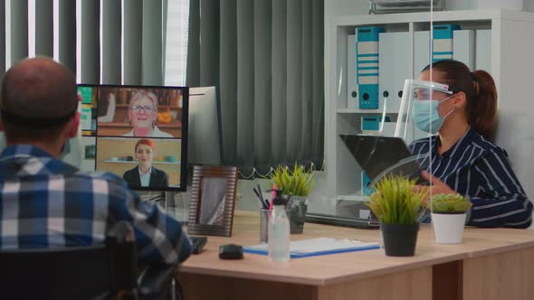 Immobilized Freelancer with Protection Mask Having Videomeeting alt