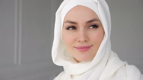 Portrait of Muslim Arabian Woman Wearing Hijab Looking at Camera and Smiling alt