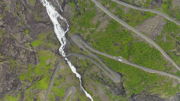 Aerial View Of Vehicles Driving On Serpentine Mountain Road Trollstigen In Rauma, Norway Passing By alt