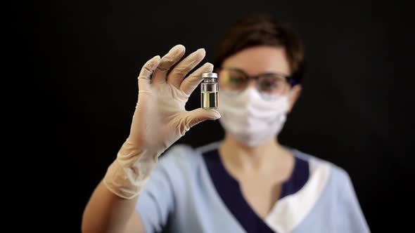 A Doctor or Nurse in Nitrile Gloves Holds in His Hand a Vaccine Vaccinated Against Influenza