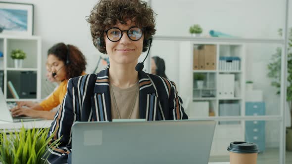 Portrait of Pretty Young Woman Call Center Employee Sitting in Workplace Alone alt