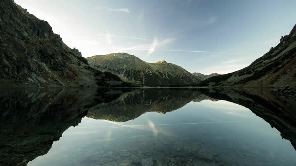 Time lapse symetrical reflection in mountain lake Tatra National Park Poland