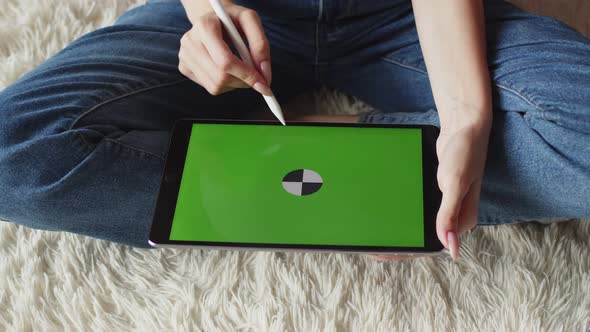 Womans Hands Draw with Stylus on Chromakey Screen of Graphic Tablet Top View Closeup alt