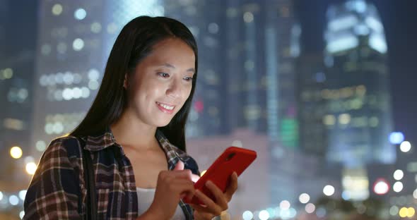 Woman use of smart phone city night
