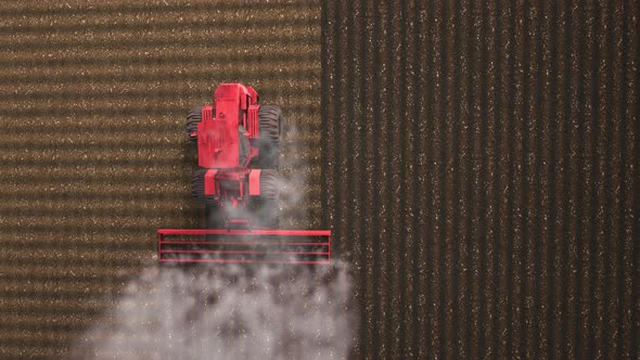 Shooting from drone flying over tractor with harrow system