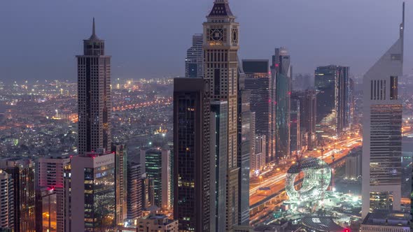 Skyline of the Buildings of Sheikh Zayed Road and DIFC Aerial Night to Day Timelapse in Dubai UAE alt